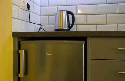 a tea kettle sitting on top of a kitchen counter at Nicola's Apartments in Kassiopi