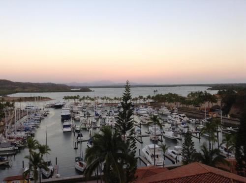 a marina with boats in the water at sunset at Grand Isla Navidad Golf & Spa Resort with Marina in Barra de Navidad