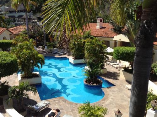 an overhead view of a swimming pool with palm trees at Grand Isla Navidad Golf & Spa Resort with Marina in Barra de Navidad