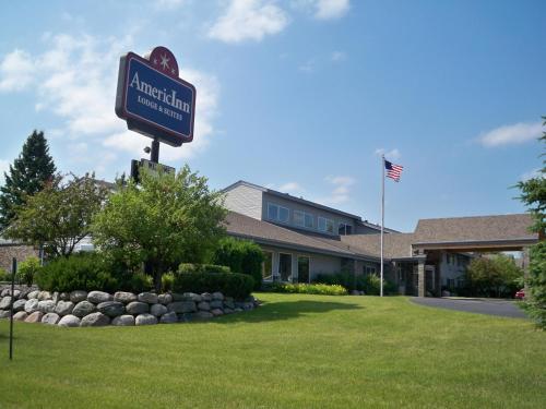 a sign for an american restaurant in front of a building at AmericInn by Wyndham Rhinelander in Rhinelander