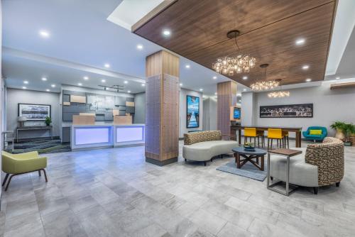 a lobby of a hospital with chairs and tables at Holiday Inn Express & Suites Moncton by IHG in Moncton