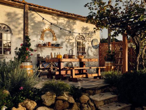 a patio with a wooden table and a tableablish at Villa Castelletto heated pool jacuzzi in Kipseli
