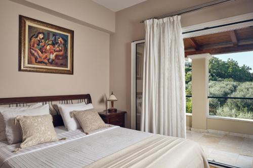 a bedroom with a large bed and a window at Villa Castelletto heated pool jacuzzi in Kipseli