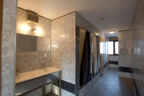 a bathroom with a sink and a mirror at Hostel Siennicka in Warsaw