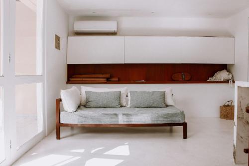 een woonkamer met een bank in een kamer bij Qavi - Pipa Atlântico Bungalow 08 in Pipa