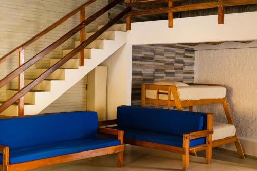 two blue chairs in a room with a bunk bed at Las Casitas in Rincon de Guayabitos