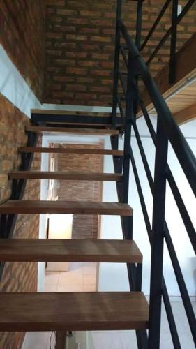 a set of wooden stairs in a building at Duplex Chacabuco in San Fernando del Valle de Catamarca
