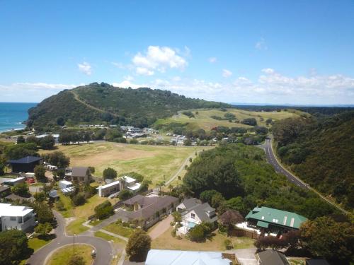 an aerial view of a small town with a mountain at Bali Escape, tropical gardens, close to 3 beaches! in Bowentown