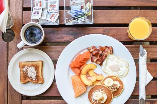a plate of breakfast food with eggs bacon and toast at Quinta Monasterio in Valle de Guadalupe