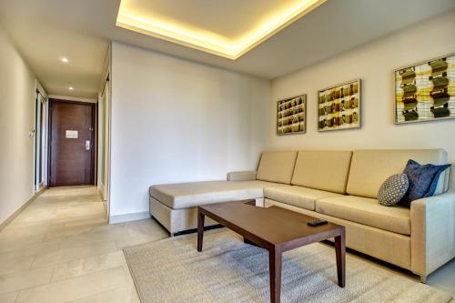 a living room with a couch and a coffee table at Royalton Riviera Cancun, An Autograph Collection All-Inclusive Resort & Casino in Cancún