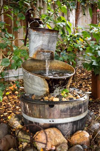 a water fountain in the middle of a garden at J Patrick Inn in Cambria