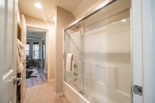 a bathroom with a shower with a glass door at Thousand Hills Golf Resort in Branson