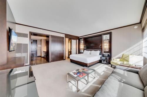 a hotel room with a bed and a couch at Jet Luxury at The Vdara in Las Vegas