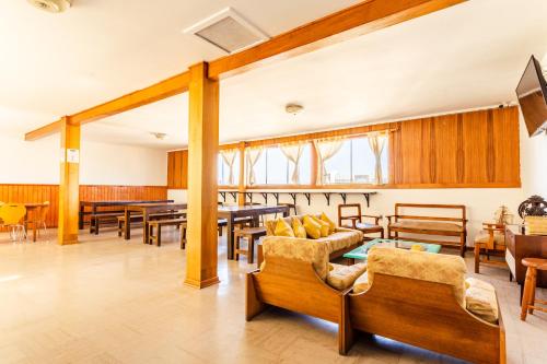 a living room with wooden furniture and a table at Hostel Del Puerto in Coquimbo