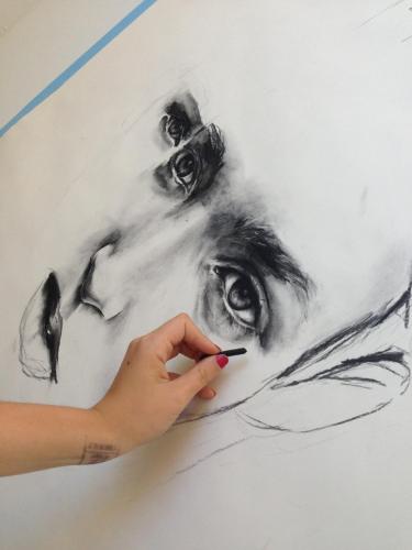 a person painting a drawing of a woman at Colonia Suite Apartments in Colonia del Sacramento