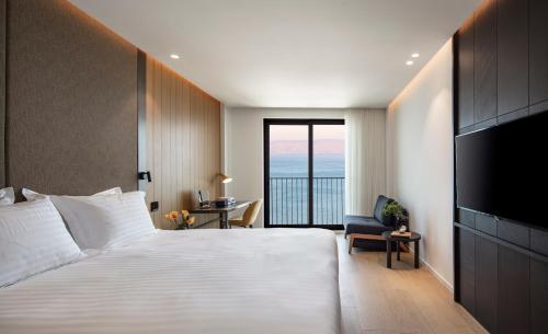 a hotel room with a bed and a television at Sofia Hotel Sea Of Galilee in Tiberias