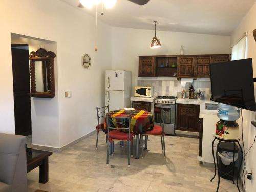 a kitchen with a table and chairs and a refrigerator at Aventura Pacifico Boutique Suites & Villas in Bucerías
