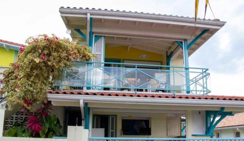 a house with a balcony on top of it at Les marches de Paulina in Sainte-Luce