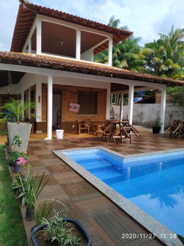 a villa with a swimming pool and a house at Alter do chão Caribe do Norte in Alter do Chao