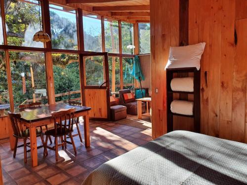 a bedroom with a bed and a desk and a table at Finca Terra Viva in Monteverde Costa Rica