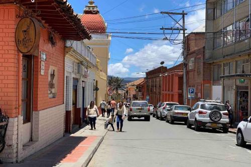 a group of people walking down a city street at Apartamento zona colonial lindísimo (102) in Zipaquirá