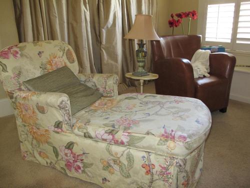 a living room with a couch and a chair at The White House Bed and Breakfast in Medford