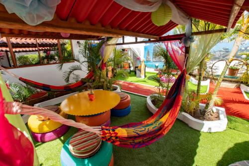 a group of hammocks in a room with plants at Hostal Gosén in Puerto Baquerizo Moreno