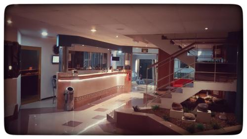 a lobby with a reception desk in a building at Hotel Enterprise Inn Plaza in León