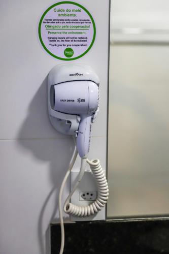 a phone with a cord plugged into a wall at POUSADA JURERE DA CANASTRA in Vargem Bonita