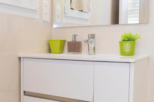 a bathroom vanity with a sink and a mirror at La Cueva de Villahormes in Villahormes