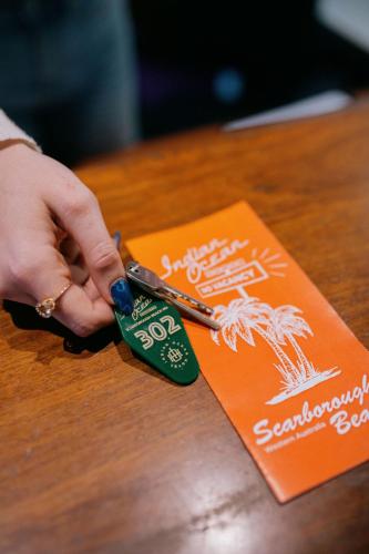 a person holding a credit card and a pair of scissors at Indian Ocean Hotel in Perth