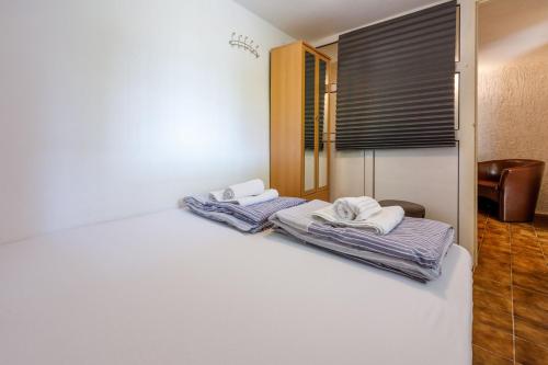 Postel nebo postele na pokoji v ubytování Apartments ALEX