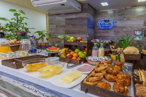 a buffet with different types of food on a table at Hotel Calimera in Santa Teresita