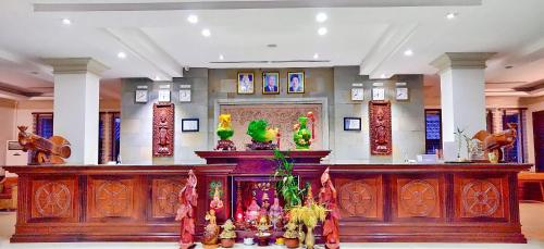 a lobby with a large wooden altar in a building at Glorious Hotel in Kompong Thom