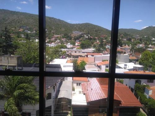 a view of a city from a window at Ayres de Las Sierras in Villa Carlos Paz