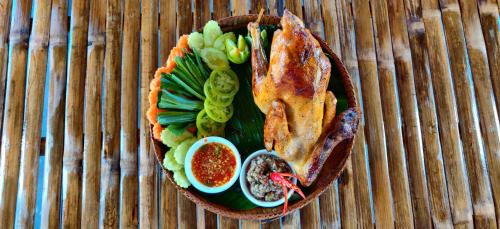 a plate of food with meat and vegetables on a table at Glorious Hotel in Kompong Thom