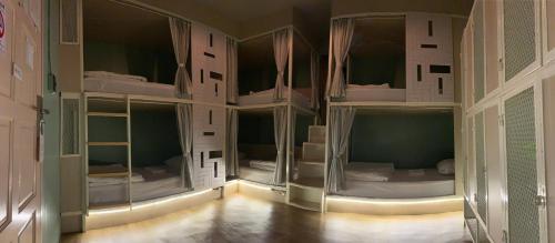 a room with four bunk beds in it at Busket Hostel in Chiang Rai