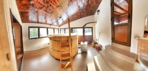 a large room with a large barrel in the middle of it at CABANA ZIMBROAIA 8 camere -Muntii Bârgăului, Transilvania in Piatra Fantanele
