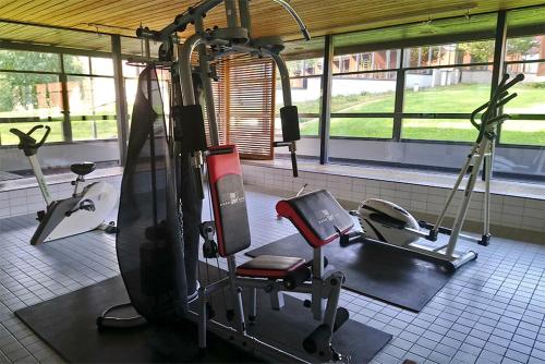 a gym with two tread machines and a treadmill at Finlandia Hotel Isovalkeinen in Kuopio