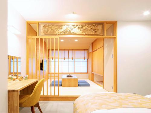 a bedroom with a bed and a desk and a table at Tanakaya Kyoto Karasuma in Kyoto