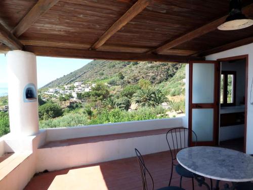 a view from the balcony of a house with a table and chairs at Case al Mare - terrazzi panoramici e ampio giardino in Santa Marina Salina