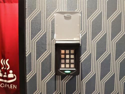a cell phone is attached to a wall at Green Rich Hotel Nagoya Nishiki (Artificial hot spring Futamata Yunohana) in Nagoya