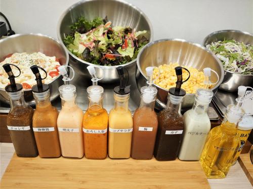 a group of bottles on a table with food at Green Rich Hotel Nagoya Nishiki (Artificial hot spring Futamata Yunohana) in Nagoya