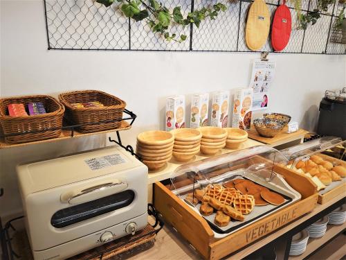 a bakery with waffles and pastries on a counter at Green Rich Hotel Nagoya Nishiki (Artificial hot spring Futamata Yunohana) in Nagoya