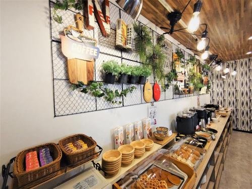 a bakery with a buffet of food on a counter at Green Rich Hotel Nagoya Nishiki (Artificial hot spring Futamata Yunohana) in Nagoya