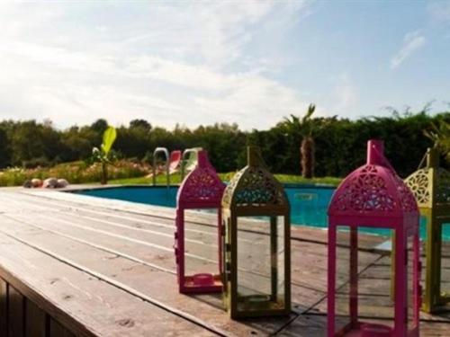 Le Clos Marie في لانغياش: مجموعة من الأشياء الملونة جالسة بجوار حمام السباحة