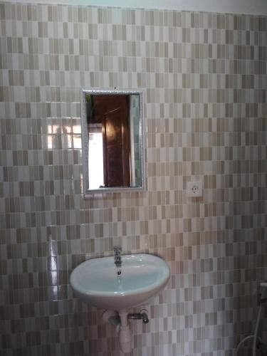 a bathroom with a sink and a mirror at Bemo Villas & Pool in Karangasem
