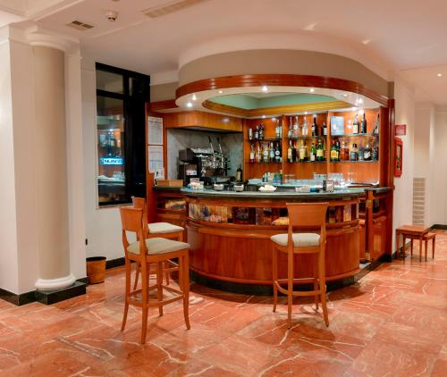 a bar in a restaurant with wooden bar stools at Hotel dei Platani in Nola