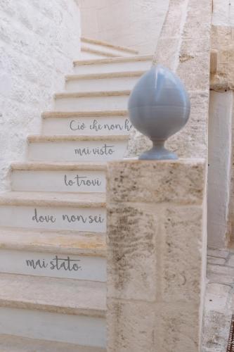 a blue ball sitting on top of a stairway at Antico Mondo Rooms & Suites in Polignano a Mare