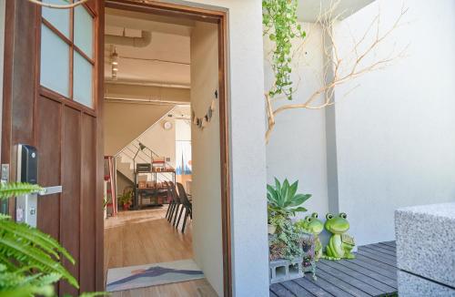 an open door to a room with plants at Travel 345 in Luzhu
